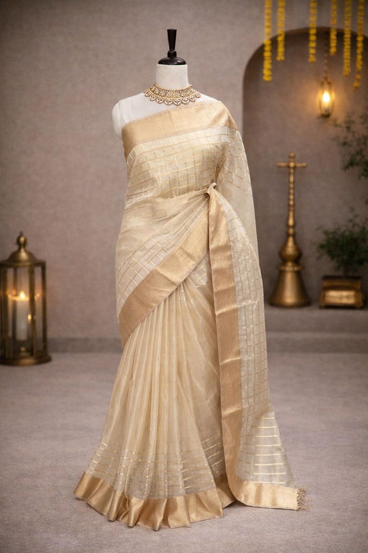 Elegant cream colored Maheshwari handloom saree with golden check patterns and a wide zari border.